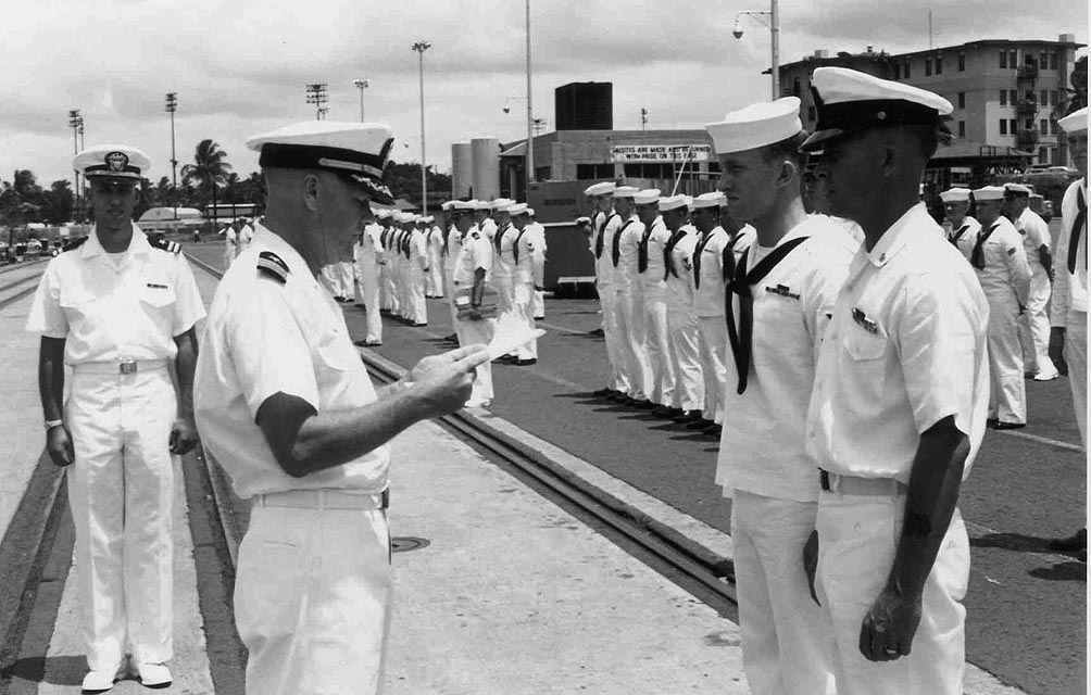 USS Sproston (DD-577) CDR Hoffman presenting award to MM1 Rankin and MMC L. Storts, Baker Pier, Honolulu, Hawaii - 1966