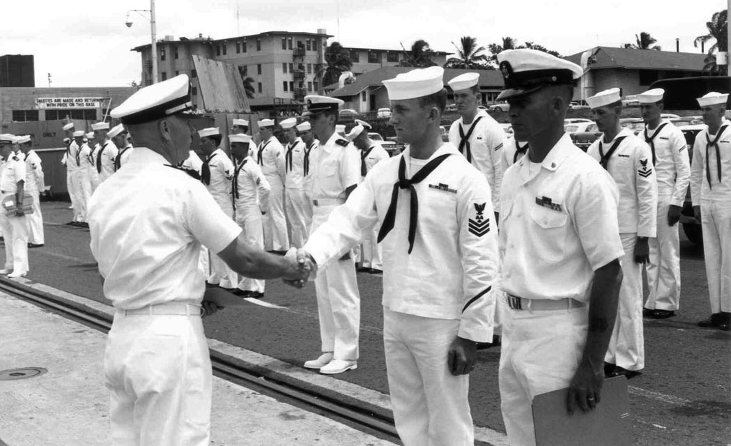 USS Sproston (DD-577) CDR Hoffman presenting award to MM1 Rankin and MMC L. Storts, Baker Pier, Honolulu, Hawaii - 1966