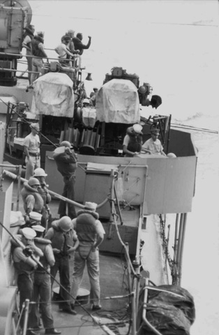 Hauling refueling lines across from the USS Kitty Hawk (CV 63)  