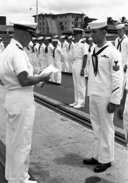 USS Sproston (DD-577) CDR Hoffman presenting award to MM1 Rankin, Baker Pier, Honolulu, Hawaii - 1966