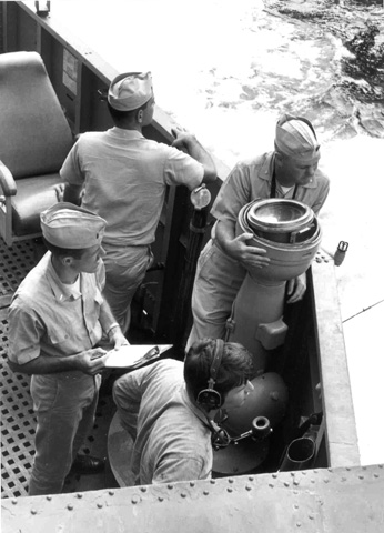 L-R LTjg Hettel, XO LCDR White, CO CDR Hoffman and unidentified sailor on the Port wing of the USS Sproston (DD577)  Bridge